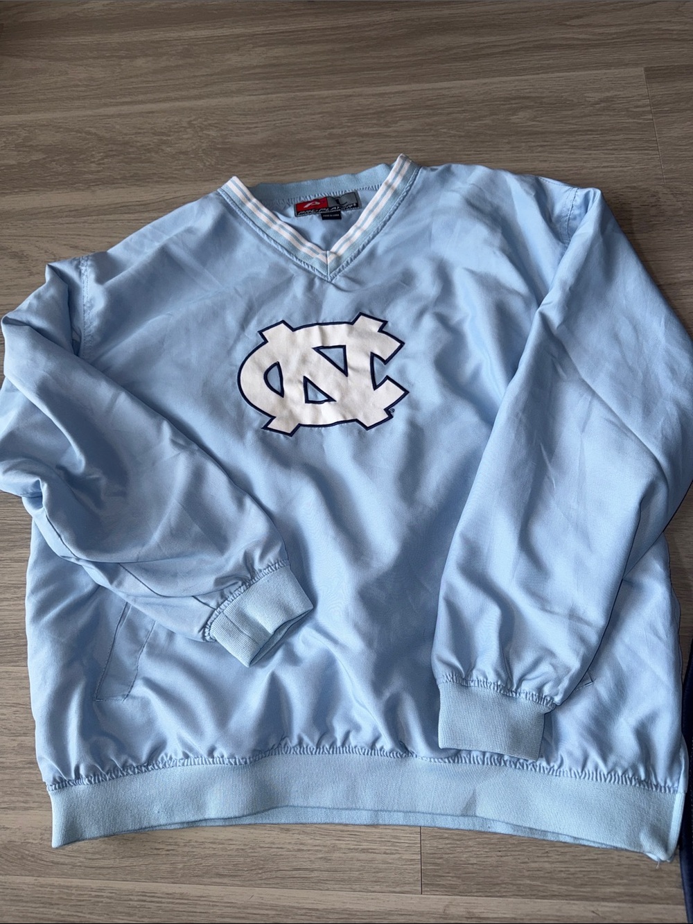 Light Blue V-Neck Men's windbreaker with UNC Logo